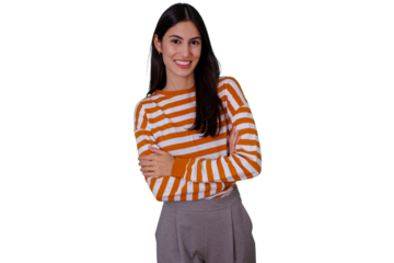 Confident young woman smiling, posing with crossed arms, wearing striped sweater on transparent background