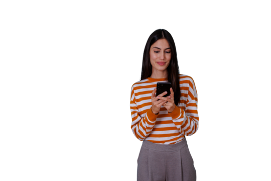 Young woman smiling while typing on smartphone, using mobile internet for social media browsing and communication