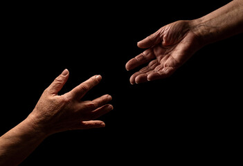 Fototapeta premium Help hands holding together representing friendship, partnership, help and hope, donation. Helping old. Hand is helping older hand