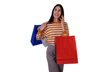 Happy woman talking on phone while shopping, carrying fashion bags and enjoying retail therapy with a transparent background