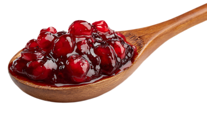A wooden spoon filled with a dark red jam like substance and whole red berries on a black background