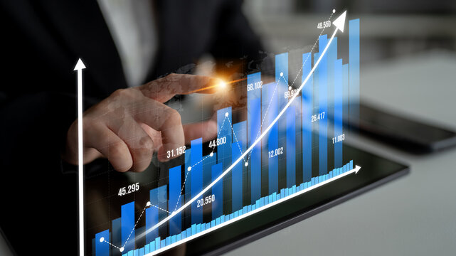 A professional setting showcasing a person interacting with digital charts and graphs on a tablet, illustrating business growth and data analysis for strategic decisions. Tessel