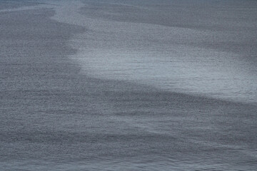 Close-up view of water with dynamic flow patterns in the Faroe Islands — nature’s texture in motion, perfect for travel and adventure imagery.