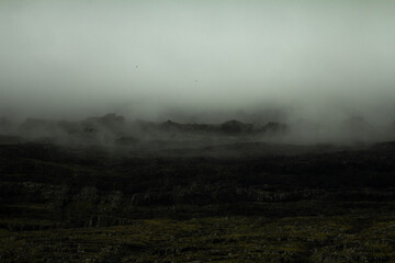Mysterious mountain wrapped in fog in the Faroe Islands, showcasing the wild beauty of the North Atlantic and inviting hiking adventures.