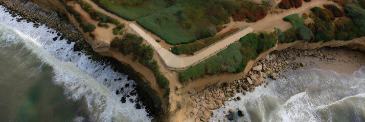 This breathtaking image captures a cliffside pathway overlooking the vibrant sea, inviting viewers to explore and appreciate the beauty and power of nature’s architecture.