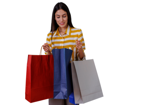 Woman standing with multiple shopping bags, checking purchased items with a happy expression. Transparent background