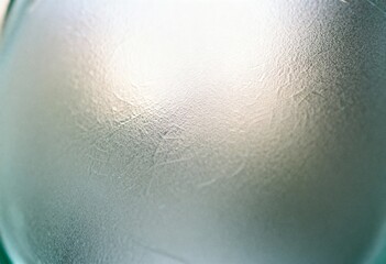 Abstract macro background of frosted, semi-translucent glass with a subtle cracked texture and soft, cool-toned light.
