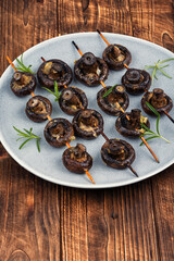Mushrooms grilled on skewers.