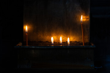 Close up of candles burning with warm flame in an orthodoxe church