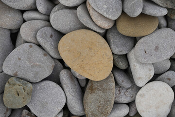 Close-up View Of A Natural Assortment Of Smooth, Rounded Grey And Brown Beach Pebbles And Rocks On The Shore In Towyn, North Wales, Uk.