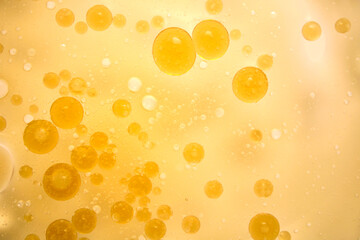 Floating Golden Bubbles in Soft Blurred Liquid Background