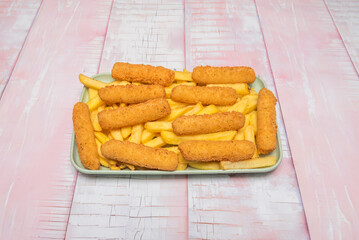 Fried chicken  topped with potato flakes and smoked paprika, served on a platter with sweet potato fries and a creamy chipotle sauce.