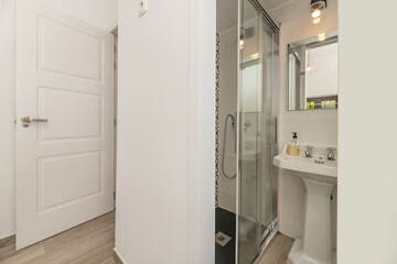 Modern bathroom with a curved corner shower, chromotherapy system, and natural stone cladding in shades of gray Neutrals