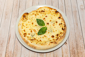 A four-cheese pizza melts its different textures with tangy Gorgonzola, mild mozzarella, aged Parmesan, and Fontina on a tomato base.