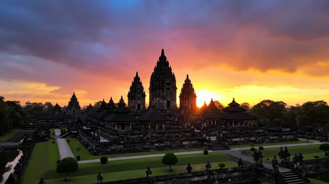 Majestic Prambanan Temple Complex Silhouetted Against a Dramatic Orange and Blue Sunset Sky