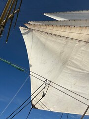 sails of a tall ship against the sky