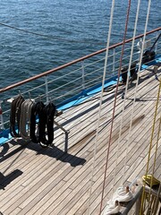 background - wooden deck and rigging of a sailboat
