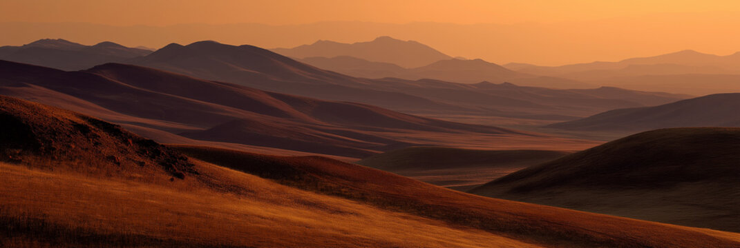 A stunning sunset illuminates rolling hills and mountains, creating a serene and tranquil atmosphere that invites reflection and appreciation of nature's beauty.