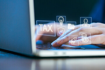 Working on tax preparation with digital tools on a laptop in a modern office setting