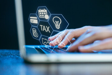 Understanding tax concepts while working on a laptop in a modern office setting
