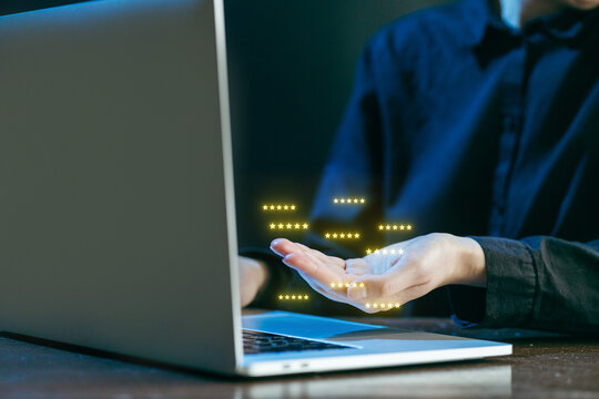 User interacts with laptop showing digital data visualization at night in modern workspace