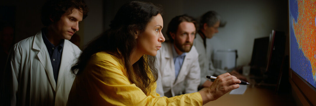 A dynamic team of scientists meticulously analyzes data on large screens, showcasing collaboration and innovative strategies essential for successful research and development efforts.