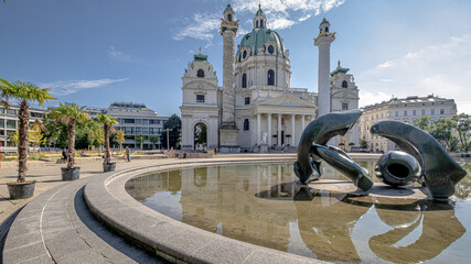 View of Karlskirche (St. Charles Church) Baroque Church, distinguished by its mighty green dome and its two left and right pillars, towering over Karlsplatz, Vienna, Austria  © MoVia1