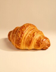 Realistic photography of a croissant in light beige aesthetic plain background