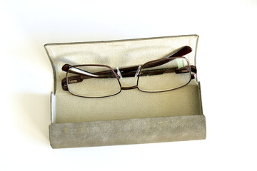 A case made of light material with glasses on a white background.