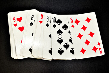A deck of playing cards on a black background.