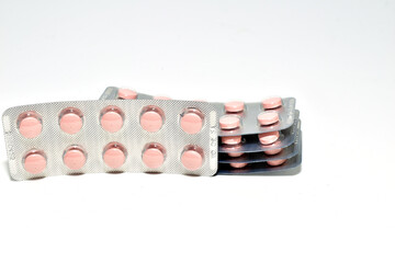 A stack of pills in a package on a white background.