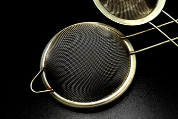 A metal strainer is a kitchen tool used in the kitchen to separate solids from liquids.