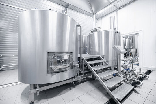 Stainless steel equipment in modern beer factory brewing process facility - Powered by Adobe