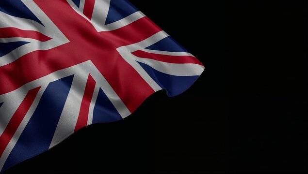 Union jack flag waving in the wind against a black background
