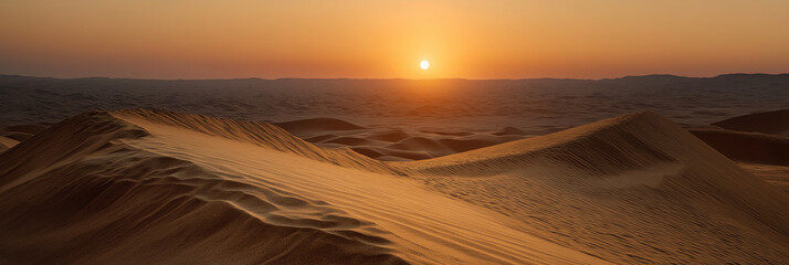The sun sets over a vast sandy desert, casting warm hues across the dunes, creating a breathtaking and serene natural landscape that evokes feelings of isolation and beauty.