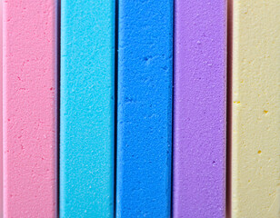 Color Spectrum: A vibrant collection of colorful chalk sticks, arranged side by side. Each stick displays a unique hue, showcasing the simplicity of a rainbow palette.