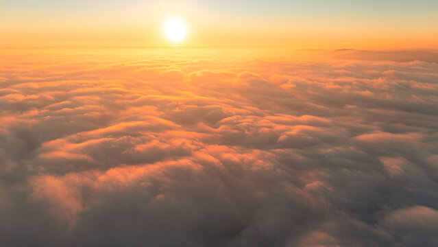 Aerial evening view of fog rolling through valleys in Bavaria with golden sunlight and soft misty hills