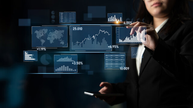 A businesswoman interacts with a digital touchscreen displaying various charts, graphs, and world data in a modern office setting, illustrating advanced data analysis. Scalp