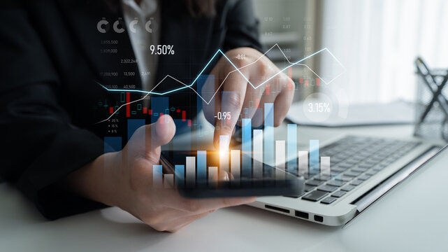 Business professional uses a smartphone to analyze financial charts and graphs, demonstrating strategic decision-making in a modern workspace focused on data insights. Scalp - Powered by Adobe
