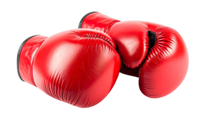 Two vibrant red leather boxing gloves resting on a surface, isolated on black