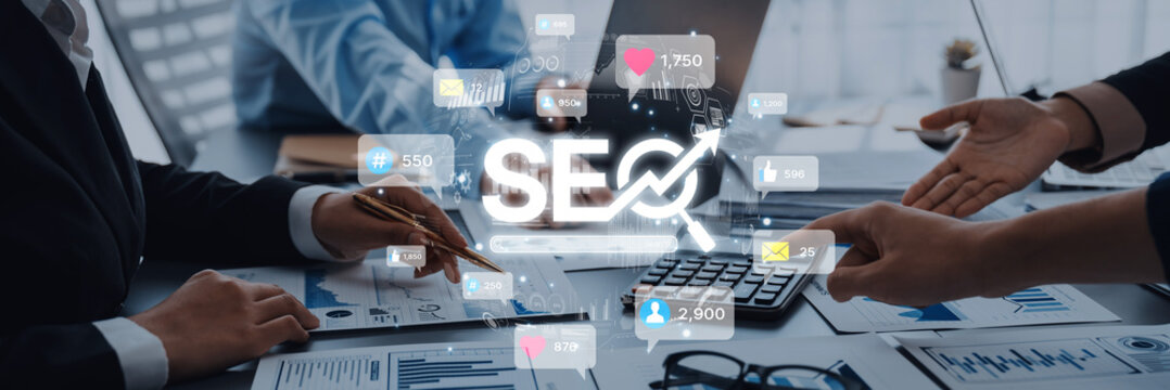 Diverse business professionals working together in an office to develop a digital marketing strategy focused on SEO and data analysis for optimal results. Trope - Powered by Adobe