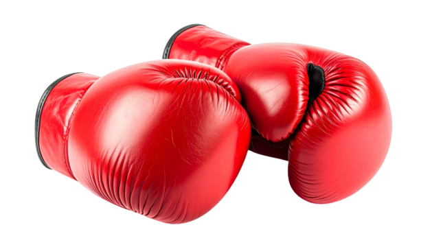Two vibrant red leather boxing gloves resting on a surface, isolated on black
