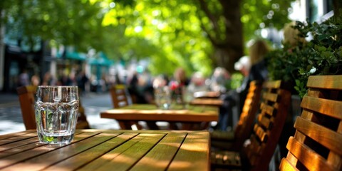 Refreshing Water Glass on a Wooden Table at Outdoor Cafe.