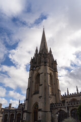 Fototapeta premium Majestic cathedral tower under cloudy sky