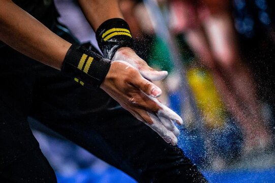 Athlete applying white chalk to their hands. Common practice in sports like gymnastics, weightlifting, and rock climbing. Ready to win. Macro, Close up - Powered by Adobe