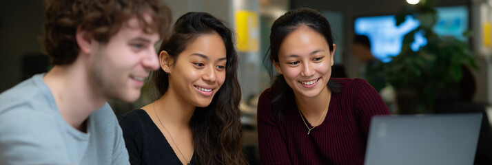 Three friends engaged in a collaborative discussion while looking at a laptop screen, showcasing teamwork, friendship, and shared ideas in a modern environment.
