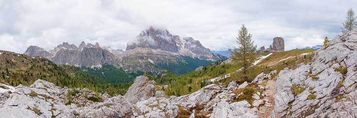 rocky hiking trail to Cinque Torri mountains, wide alpine panorama south tyrol, dolomites