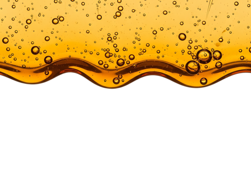 Close up of golden liquid with many small bubbles and wavy surface isolated on transparent background