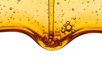 Golden liquid honey or oil pouring and dripping with air bubbles isolated on transparent background
