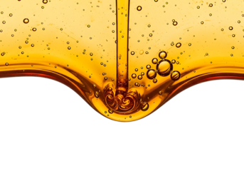 Golden liquid honey or oil pouring and dripping with air bubbles isolated on transparent background